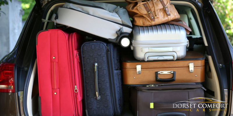 A car boot completely filled with suitcases, stuck one on top of another.