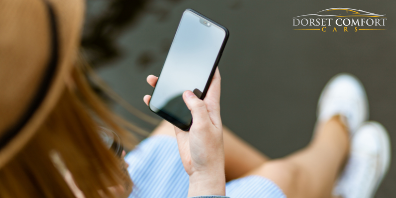 Lady using a smartphone seen over her right shoulder